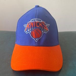 Orange, blue, and white Adidas Hat.